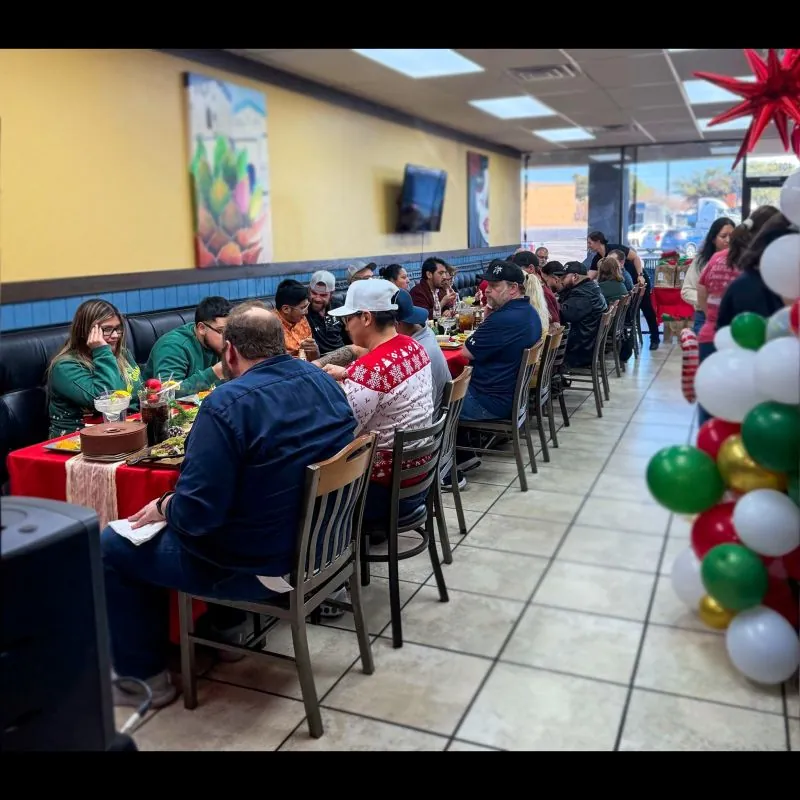 The team sharing a Christmas meal together at a long table