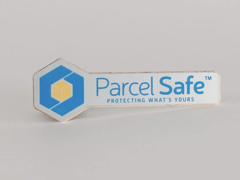 A brushed aluminum Parcel Safe logo nameplate