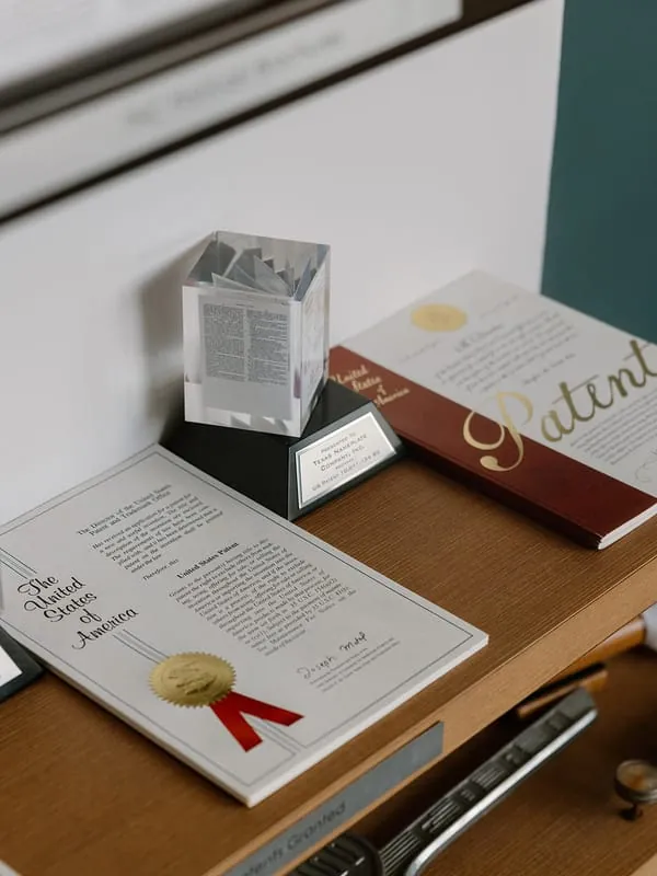 United States patent certificates and award plaque issued to Texas Nameplate Company