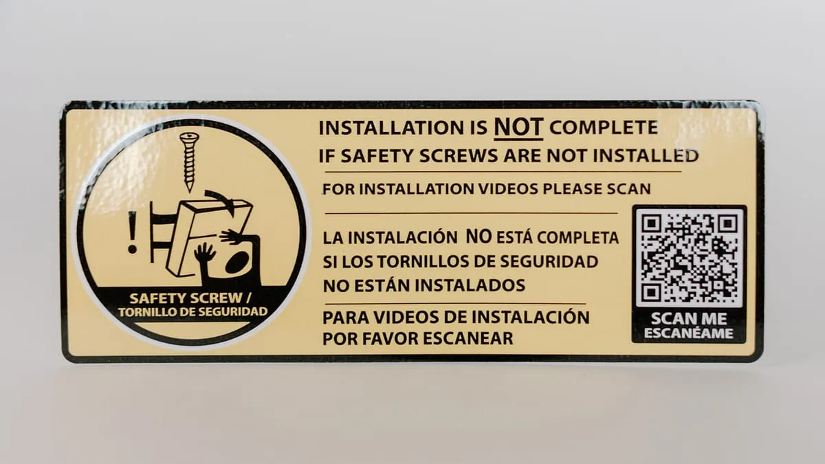 A bilingual safety-screw warning decal with a QR code for installation videos