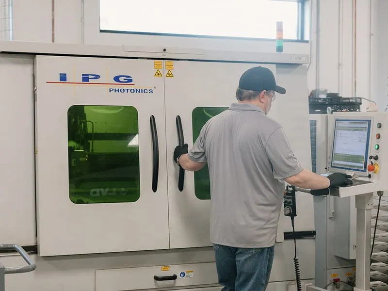 An operator working at the fiber laser control console