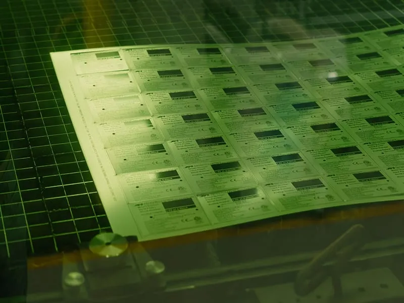 A nameplate sheet on the fiber laser bed
