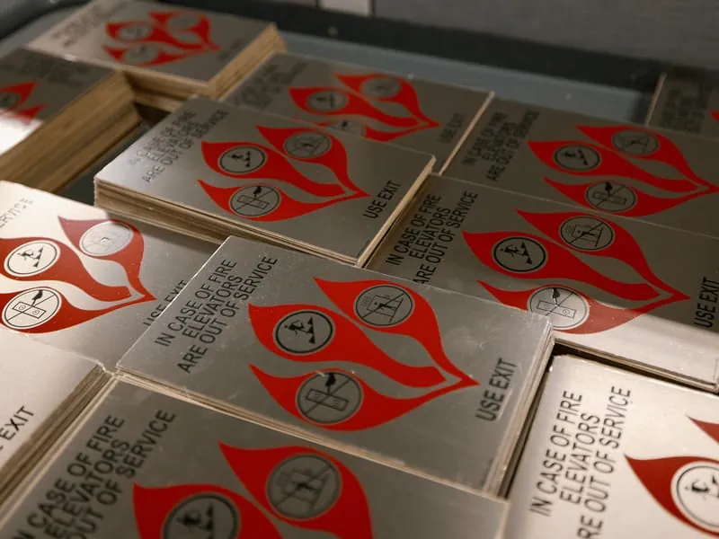 Stacks of brushed metal fire and elevator safety plates