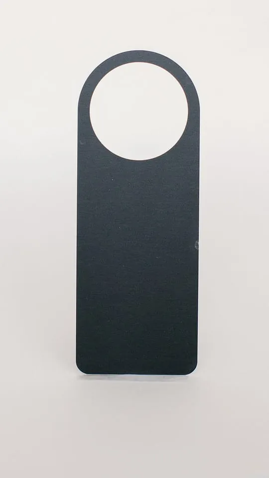 A black anodized hang tag with a large mounting hole