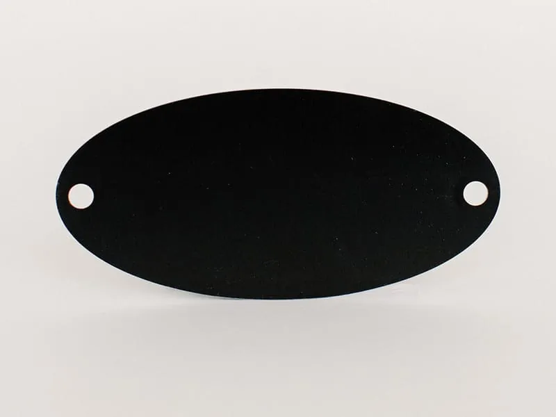 A blank black oval tag with mounting holes at each end