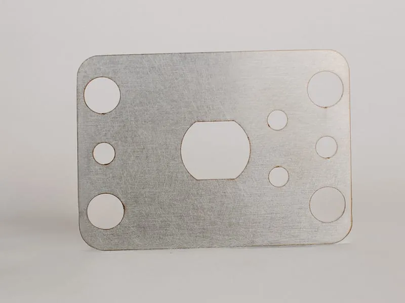 A blank aluminum plate punched with mounting holes and a center cutout
