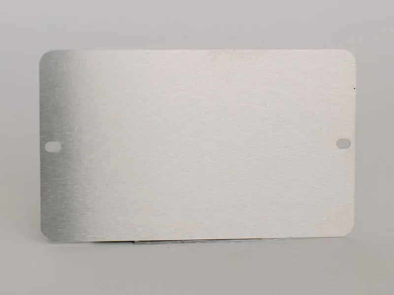 A blank brushed aluminum tag with mounting holes
