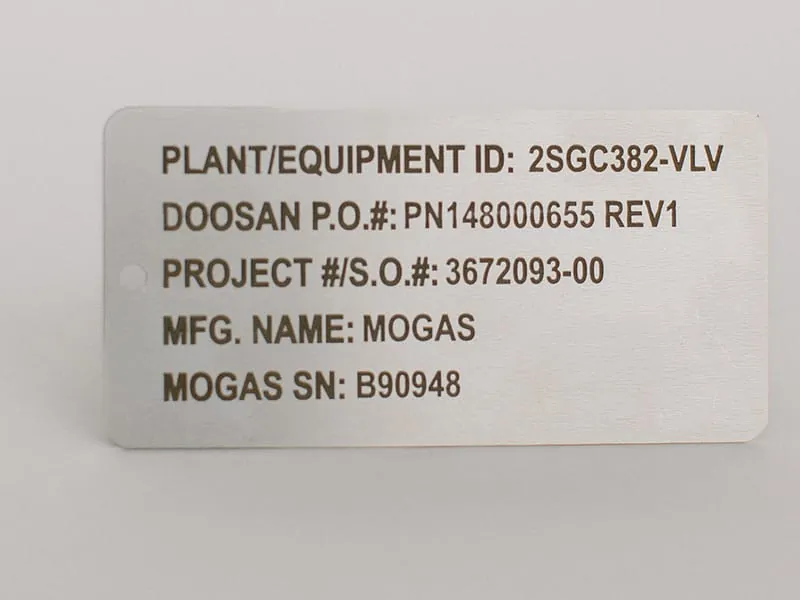 A stainless valve identification plate with plant, project, and serial fields