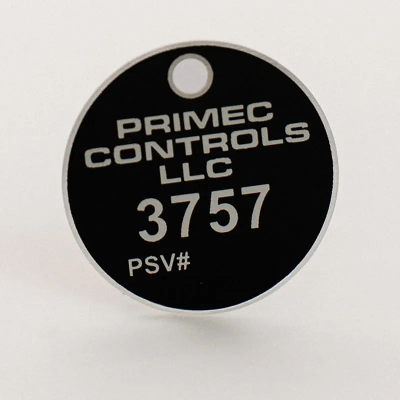 A round black valve tag engraved Primec Controls with a PSV number